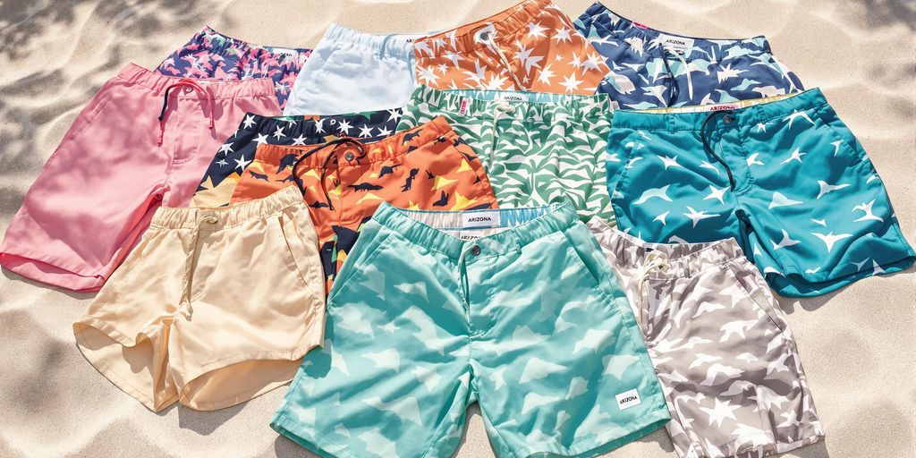 Colorful Arizona shorts laid on sandy desert background.